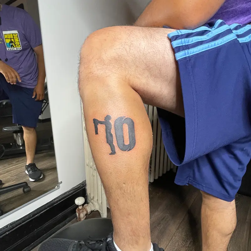 Blackwork number 10 tattoo with a soccer player silhouette as the 1, on the calf, by Andres at Killer Silver Tattoo