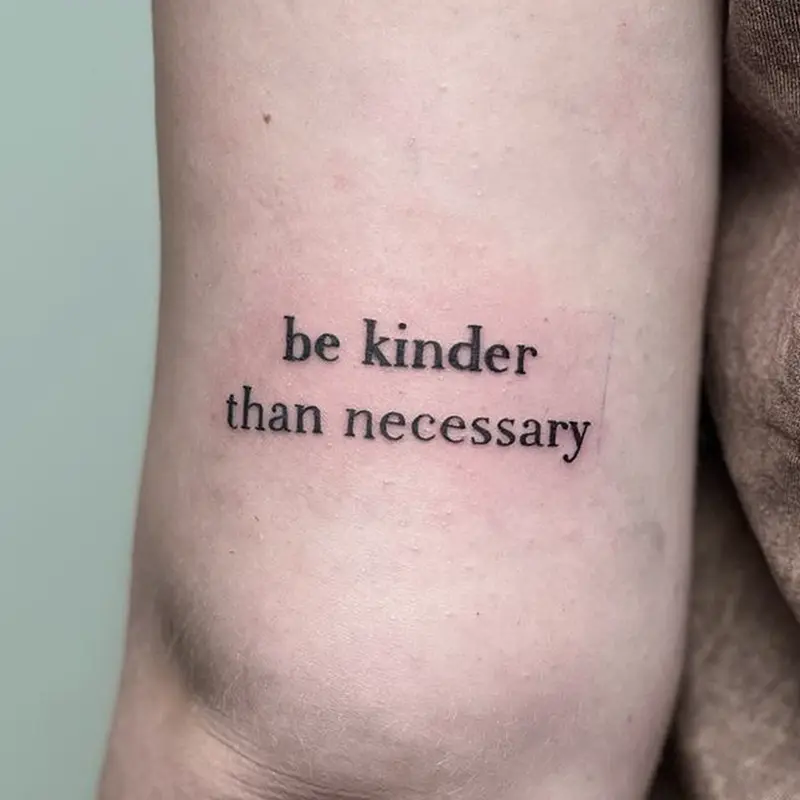 "Be kinder than necessary" script lettering tattoo on arm — Killer Silver Tattoo Studio