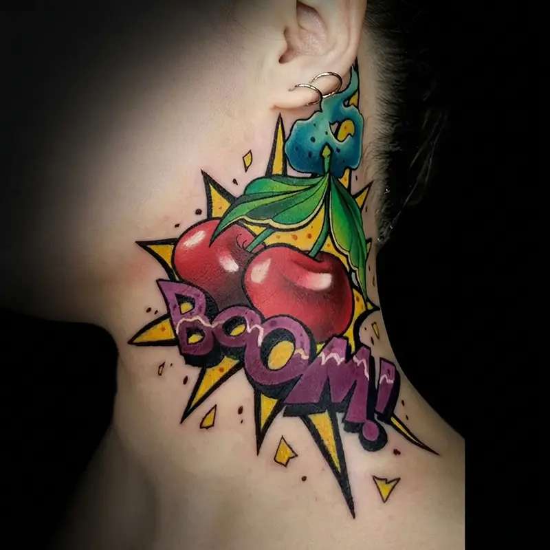 Pop-art cherry tattoo with comic-style lettering by guest artist Bence Kormos at Killer Silver Tattoo Studio