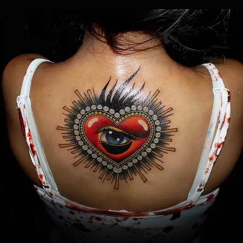 Sacred heart and eye tattoo on upper back by guest artist Bence Kormos at Killer Silver Tattoo Studio