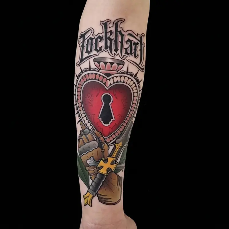 Heart lock and dagger tattoo with custom lettering by guest artist Bence Kormos at Killer Silver Tattoo Studio