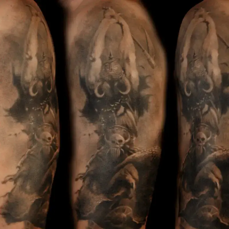 Black and gray realism tattoo reproducing Frank Frazetta's Death Dealer, a horned, skull-faced warrior, on the upper arm