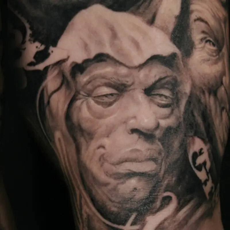 Black and gray realism tattoo of a heavy-lidded hooded face personifying sloth, from a seven deadly sins sleeve