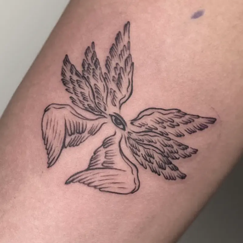 Fine-line winged eye tattoo, illustrative feather design, on forearm — Killer Silver Tattoo Studio