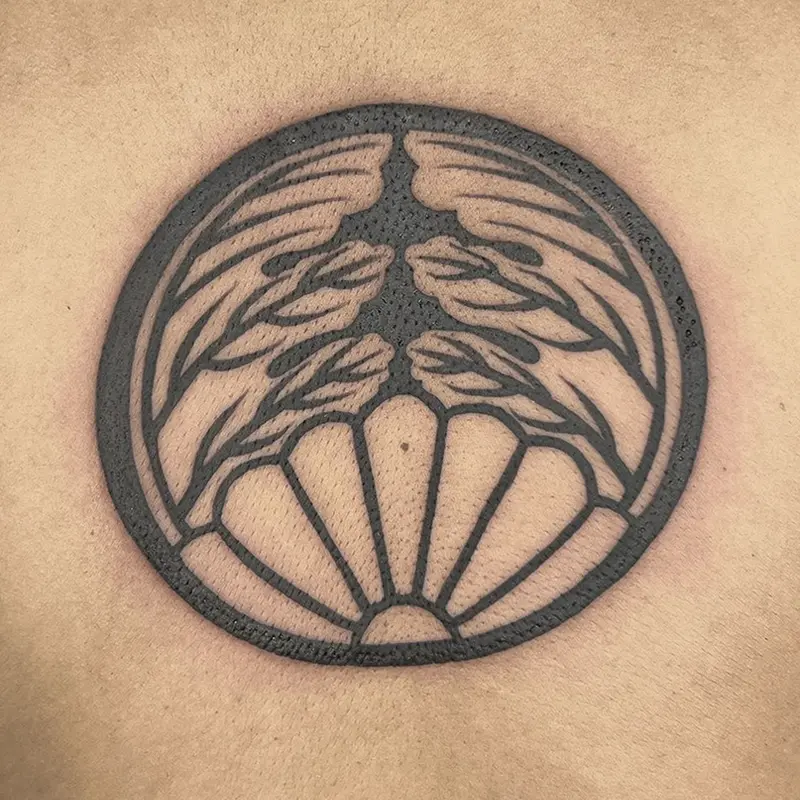 Bold blackwork Japanese crest tattoo on upper back — Killer Silver Tattoo Studio