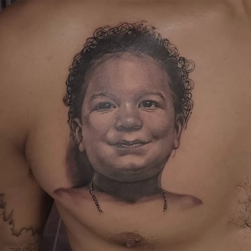 Black and gray realism memorial portrait tattoo of a child's face, by Philipus