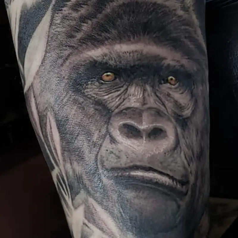Black and gray realism tattoo of a gorilla's face, by Philipus