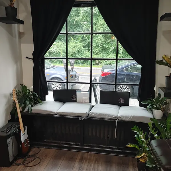 The finished front window at Killer Silver Tattoo Studio, 34 Garth Rd in Scarsdale, NY, with a cushioned window seat