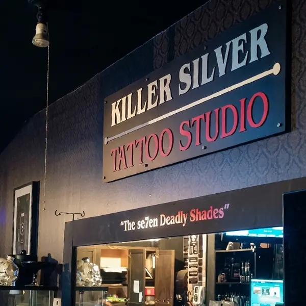 Killer Silver Tattoo Studio sign above a doorway lettered The Se7en Deadly Shades inside 172 Avenue B