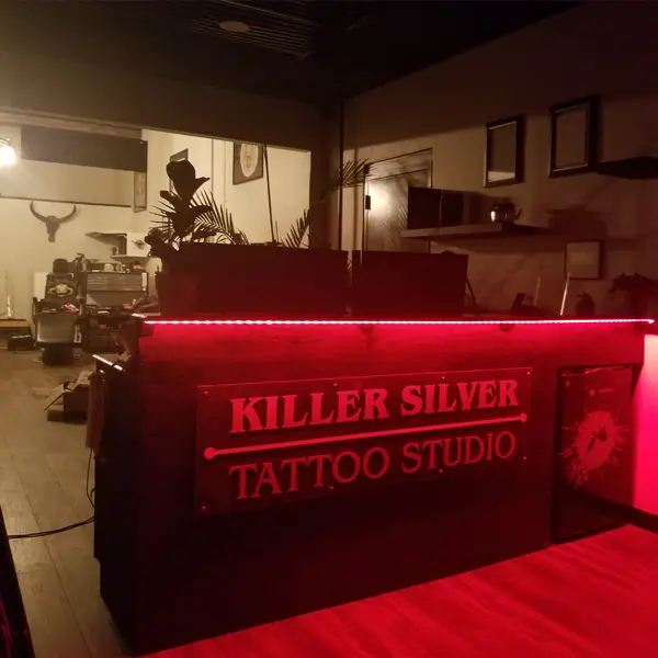 Red-lit Killer Silver Tattoo Studio front desk at 34 Garth Rd in Scarsdale, NY, days before opening, 2021